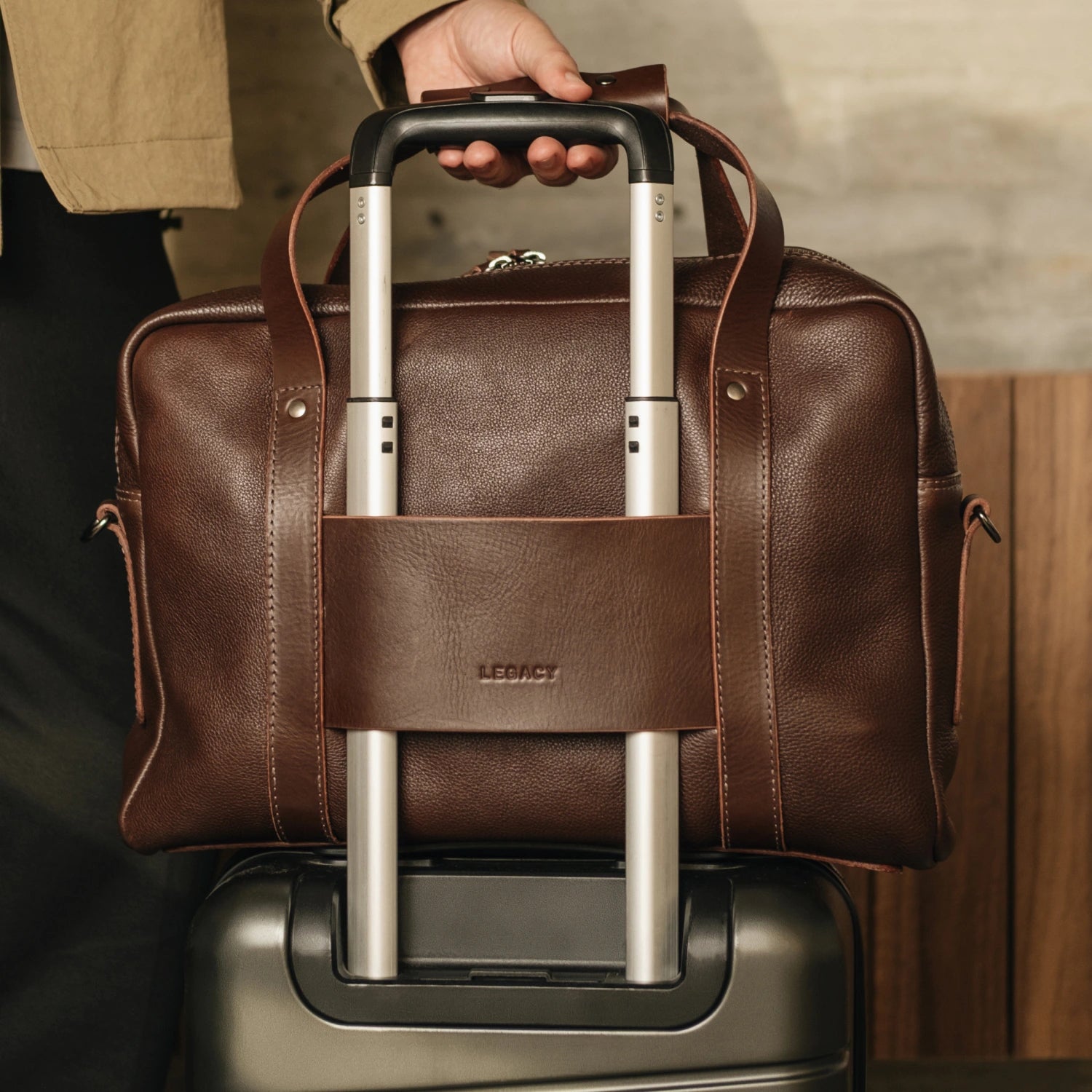 Nordweg Legacy Leather Briefcase in espresso threaded onto a luggage trolley handle via the back sleeve