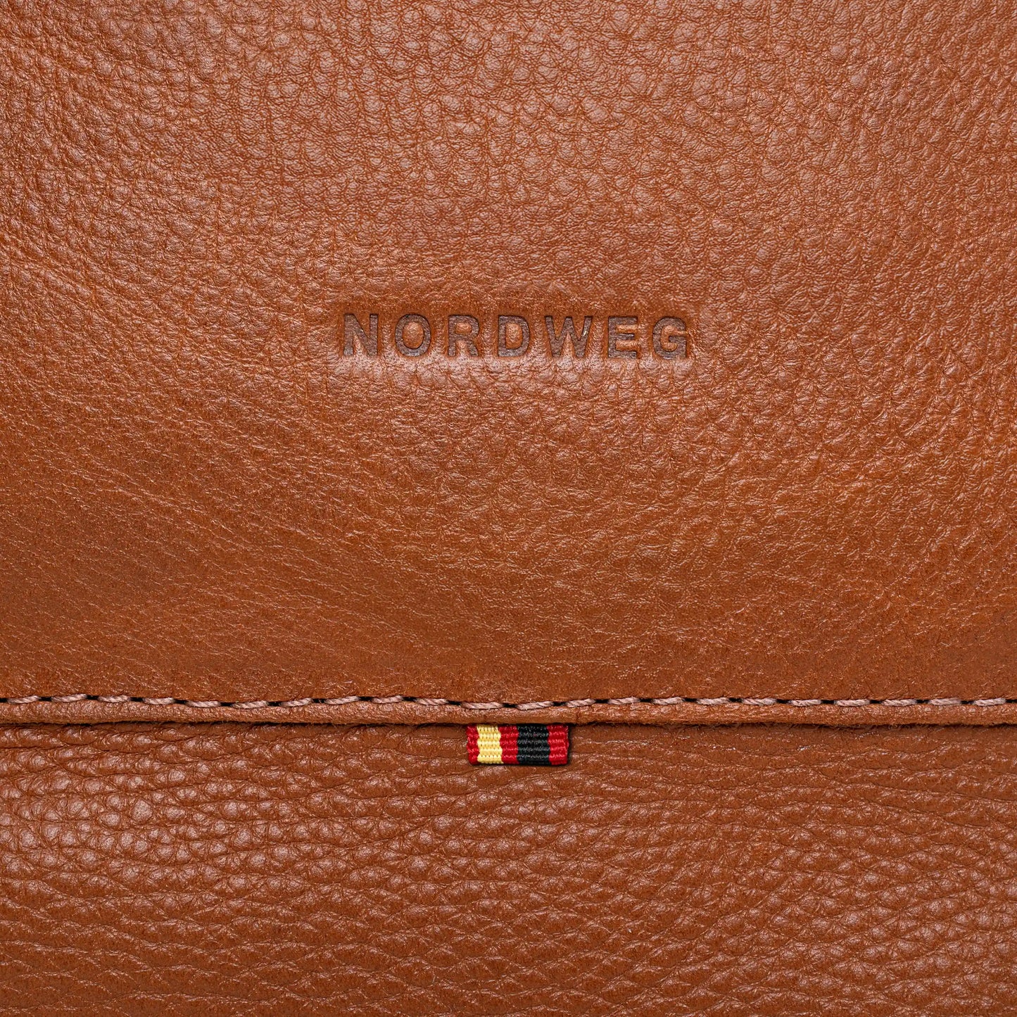 Logo Nordweg em relevo no couro Floater full grain anilina – Mochila Legacy Cognac