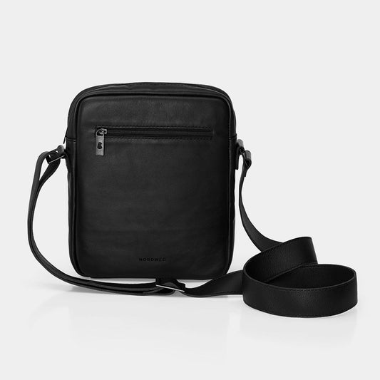 Nordweg Nomad leather crossbody sling bag in black, front view with zipper pocket and shoulder strap