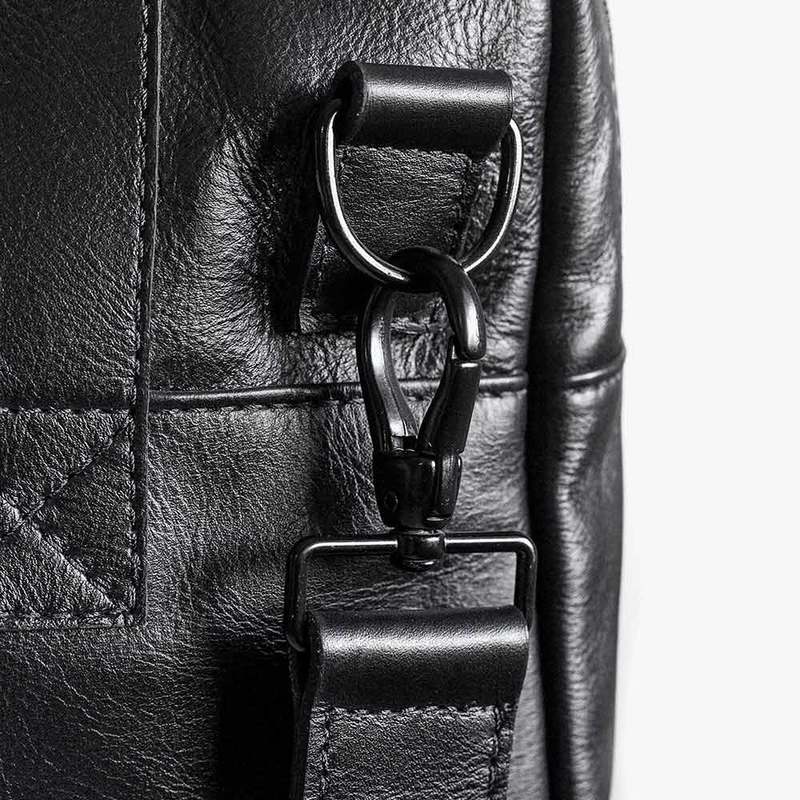 Close-up of black Nordweg Nomad leather weekender strap and hardware detail